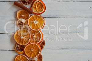 slices of orange on a white wooden surface