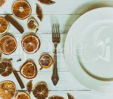 White empty plate with a fork on a white vintage wooden surface,