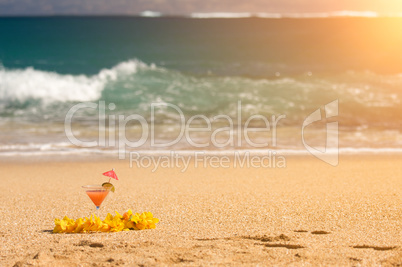 Tropical Drink and Lei on Beach Shoreline