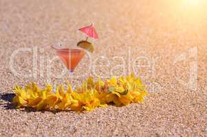 Tropical Drink and Lei on Beach Shoreline