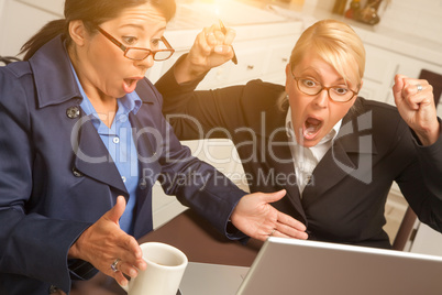 Businesswomen Celebrate Success on the Laptop