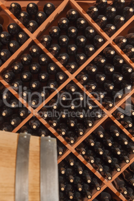 Several Varietal Wine Bottles and Barrel Age Inside Cellar