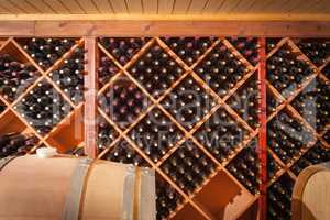 Wine Barrels and Bottles Age Inside Cellar