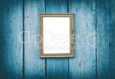 empty wooden frame hanging on blue cracked wooden wall