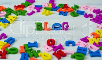 Wooden colorful letters of the English alphabet on a white woode