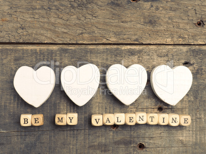 Wooden dices with white heart shapes