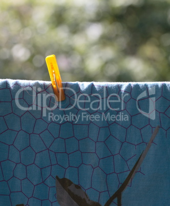 one clothespin on blue bedsheet
