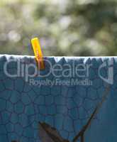 one clothespin on blue bedsheet