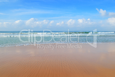 ocean, sandy beach and blue sky