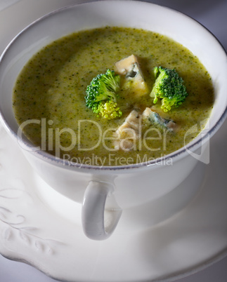 A bowl of creamy broccoli soup with blue cheese.