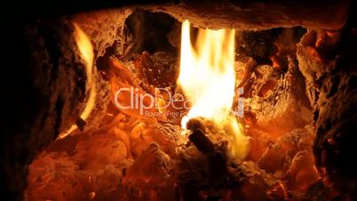 Fireplace full of bright burning wood and embers with the sound