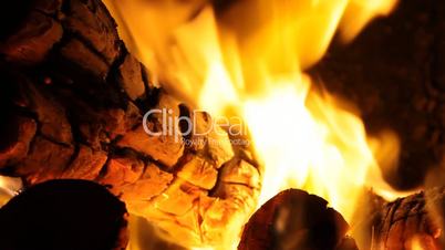 Fireplace full of bright burning wood and embers with the sound