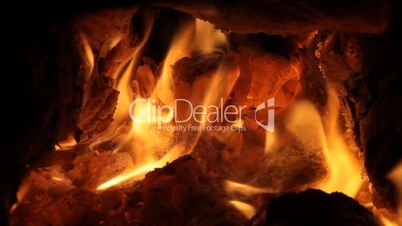 Fireplace full of bright burning wood and embers with the sound