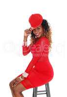 Woman in red dress and cap.