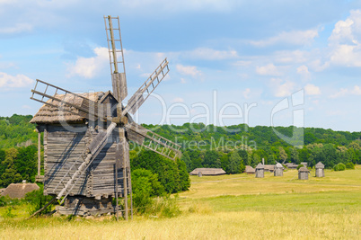 old wooden windmill in a field