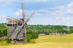 old wooden windmill in a field