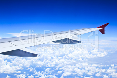 Airplane wings in the blue clouds.