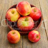 red apples on a wooden surface