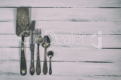 Vintage cutlery on a white wooden background