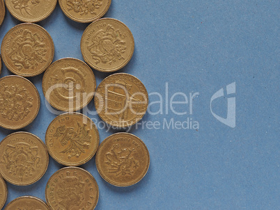 Pound coins, United Kingdom over blue with copy space