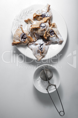 Hamantaschen Cookies for Purim on a white plate.
