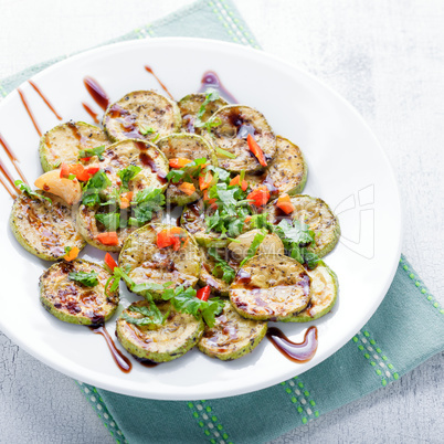 Salad with Fried zucchini on a white background.