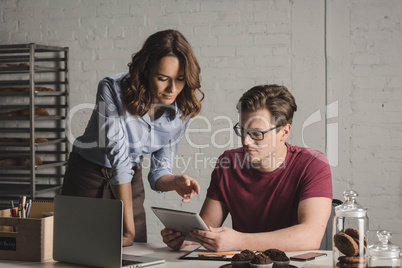 Man and woman using digital tablet