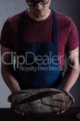 Baker holding bread