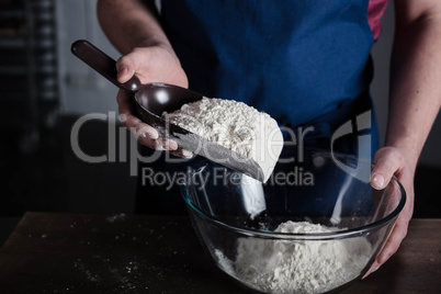 Baker sifting flour