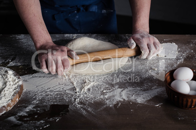 Baker rolling dough