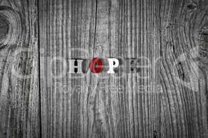 Grey wooden background with the word hope