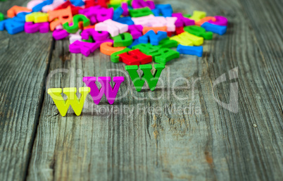 Wooden background with colorful letters of the English alphabet