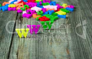 Wooden background with colorful letters of the English alphabet