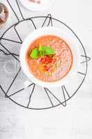 Bowl of Fresh tomato soup Gazpacho on a white background.