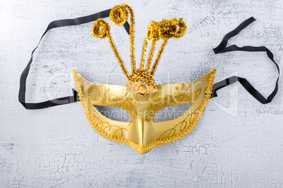 Gold carnival mask on a white background.
