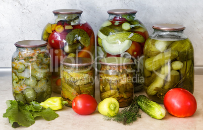 A variety of canned vegetables in glass jars.