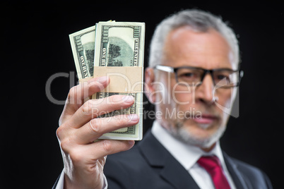 Businessman holding dollar banknotes