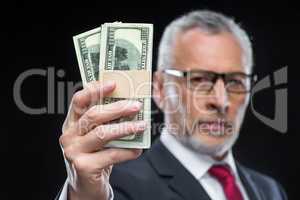 Businessman holding dollar banknotes