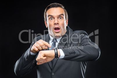 Scared businessman with wristwatch
