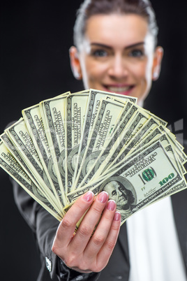 Businesswoman holding dollar banknotes