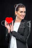 Businesswoman holding red toy heart