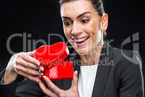 Businesswoman holding red toy heart
