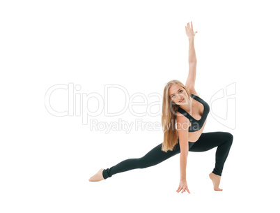 Slim sportswoman in top and leggings in studio