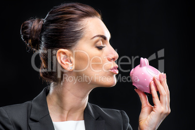 Businesswoman holding piggybank