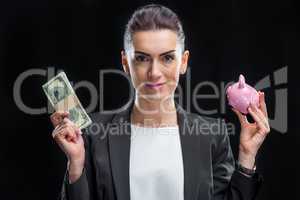 Businesswoman holding piggybank