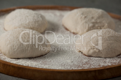 Pizza dough and flour on rolling board