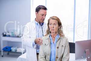 Doctor examining a senior woman