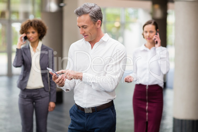 Business executive using mobile phone