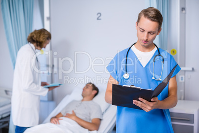 Doctor writing on clipboard Doctor writing on clipboard