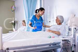 Female doctor interacting with female senior patient